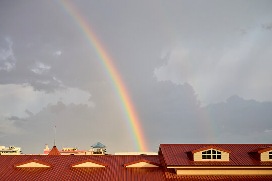 Rainbow over residential buildings with red roofs