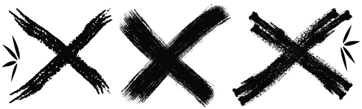 Black brush stroke x marks on white background