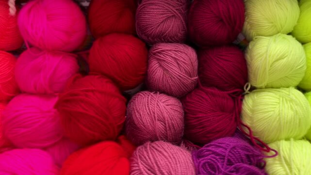 Vibrant yarn balls in various colors arranged for knitting and crafting projects