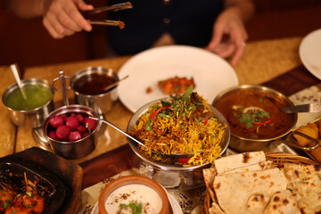 Naklejka na ściany i meble Traditional Indian Kashmiri Cuisine Spread with Biryani and Naan Bread