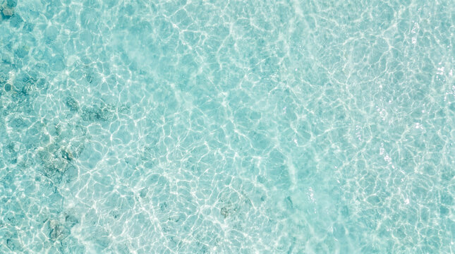Clear blue water texture ripples background with transparent background abstract shimmering sunlight caustics reflection swimming sparkling refreshing close-up