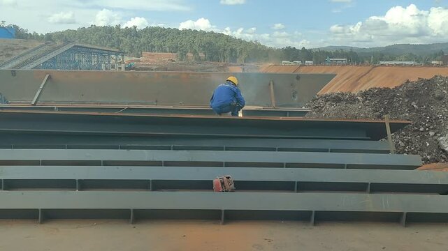 Industrial Welder Fabricating Steel Structure on Heavy Construction Site