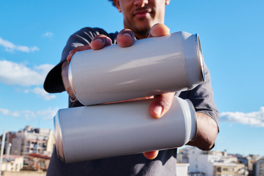 Man holding two cans