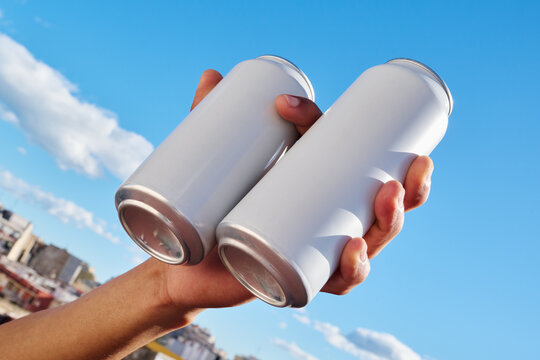 Clinking two empty cans