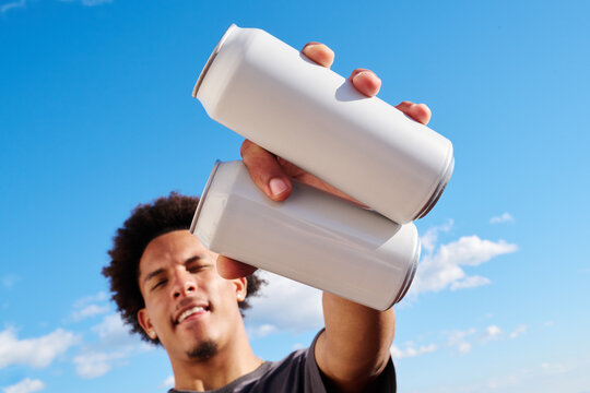 Man holding two white cans