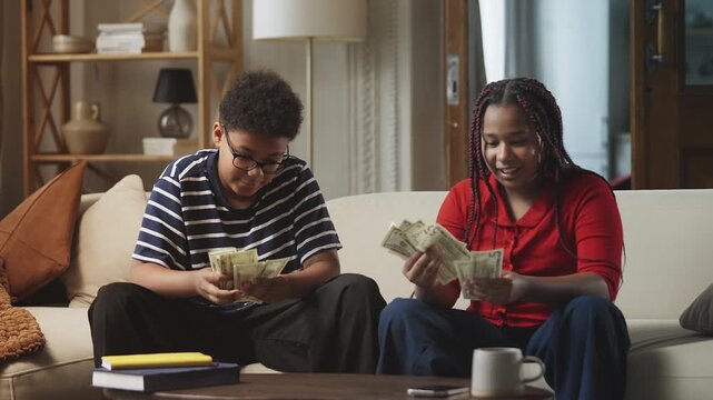 Cheerful African American children counting money, starting their own venture