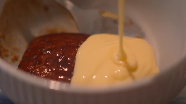 Indulgent Sticky Toffee Pudding with Custard Slowly Poured on Top for Sweet Dessert. 4K.