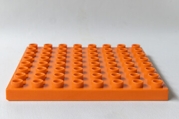 Fototapeta premium Front Perspective view Orange Square lego duplo base plate toy block brick isolated on white