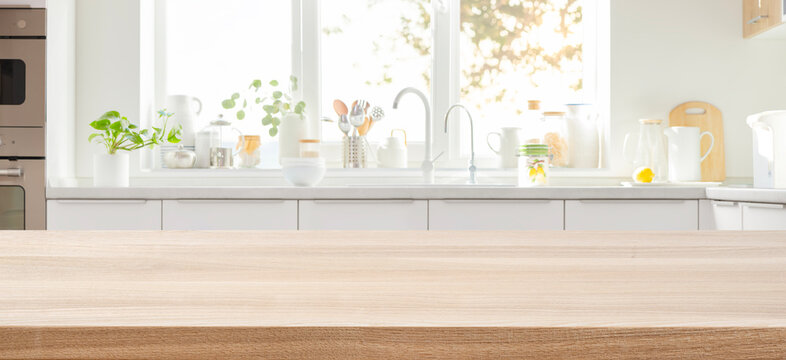 Empty space on wooden table for product display and panoramic blur modern kitchen interior as background