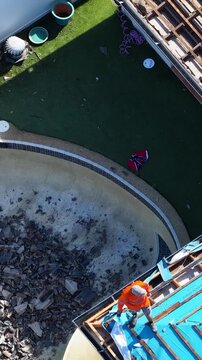 Aerial View of Construction Worker Repairing Residential Roof with Blue Sarking