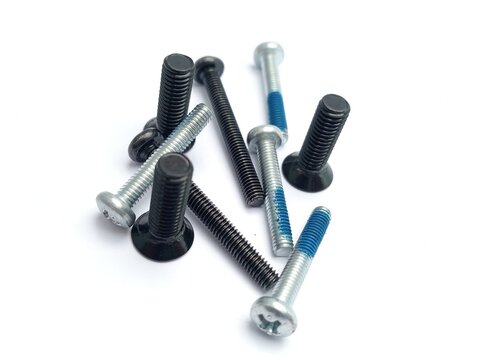 A specialized commercial product shot featuring two round, white nylon plastic rollers or flanged washers fitted with black crosshead screws in their center. The two components rest close together on 