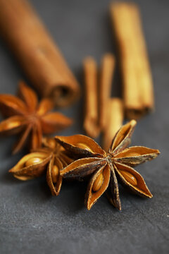 Star Anise and Cinnamon Sticks on Dark Slate Background - Aromatic Spice Flat Lay
