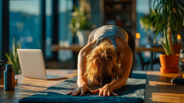 Woman in Forward Bending Stretching Yoga Pose in Bright Room