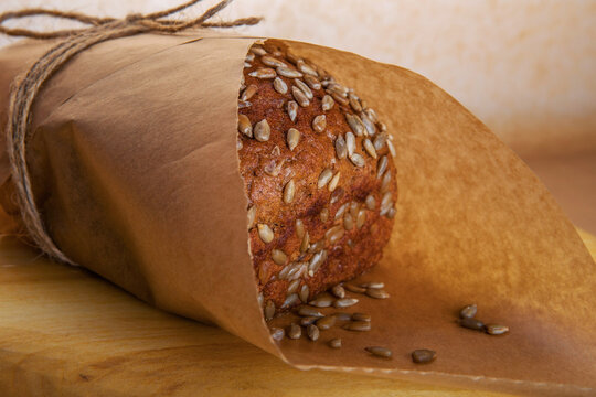 Freshly baked bread wrapped in craft paper with twine string
