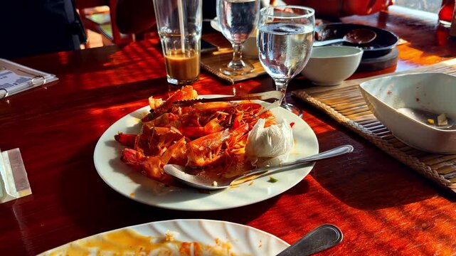 Seafood feast with prawns and rice served on a sunlit restaurant table