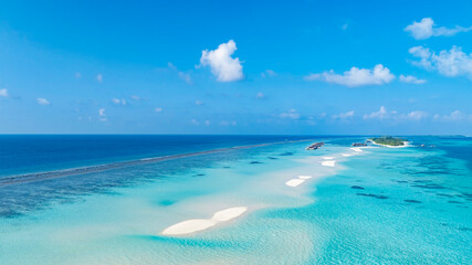 Fototapeta premium Aerial view of Summer lagoon Ripples in the sand at low tide on a beach with sandbar background and blue sea in Maldives island