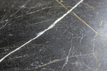 Fototapeta premium Dramatic black marble surface with striking white and gold veins, showcasing elegance and sophistication in design