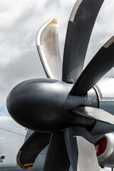 Close view large turboprop propeller military transport aircraft dramatic cloudy sky. Powerful aerospace propulsion system engineering precision aerodynamic efficiency advanced aviation technology © Kyryl Gorlov