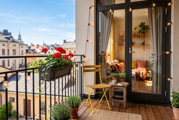 Obraz premium Cozy apartment balcony with yellow chair and string lights
