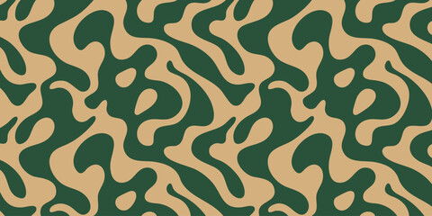 A close-up view of a green and beige camouflage pattern on fabric © Dhani