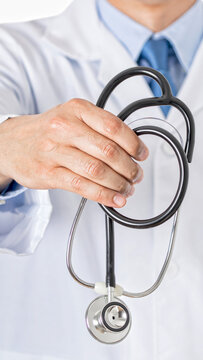 unrecognizable male doctor offering out an stethoscope