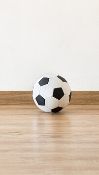 Soccer ball next to a white wall