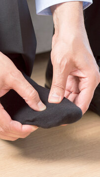 businessman suffering with foot pain in the room