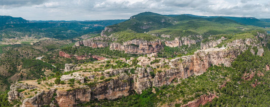 Close aerial view of Siurana village perched on towering sandstone cliffs in Catalonia, Spain.