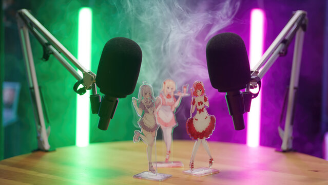 Person set up green and purple neon tubes on anime manga podcast studio