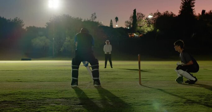 Batsman swinging on delivery, wicketkeeper throwing down stumps to run out teammate on outfield