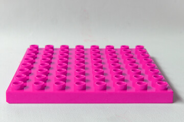 Naklejka premium Front Perspective view Bright Pink Magenta Square Lego duplo base plate toy block brick isolated on white