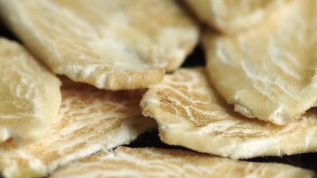 Extreme macro shot of oatmeal flakes moving along the camera, texture.