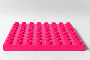 Naklejka premium Front Perspective view Bright Pink Square Lego duplo base plate toy block brick isolated on white