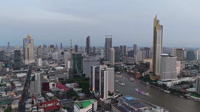 Aerial panorama of Chao Phraya River and Bangkok skyline at twilight