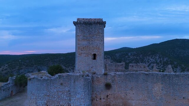 Aerial view from a drone of the sunset at the castle in the town of Ucero, in the Burgo de Osma region, Soria Province, Autonomous Community of Castile and Leon, Spain. Europe