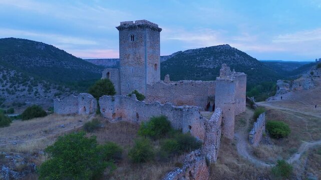 Aerial view from a drone of the sunset at the castle in the town of Ucero, in the Burgo de Osma region, Soria Province, Autonomous Community of Castile and Leon, Spain. Europe