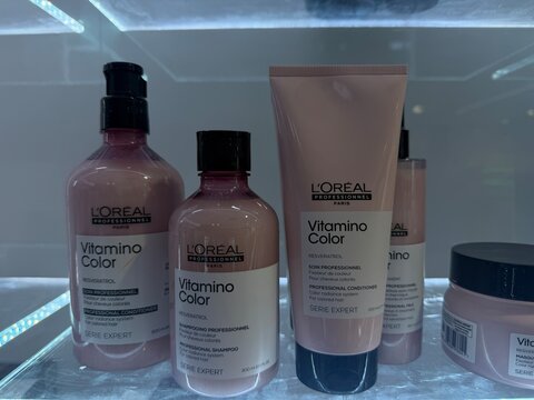 Palma de Mallorca, Spain - June 08, 2026: L'Oreal Professionnel Vitamino Color hair care products displayed on a shelf, featuring shampoo, conditioner, and treatment in pink bottles