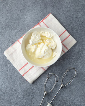 Cream cheese and condenced milk in bowl for whisking cake frosting