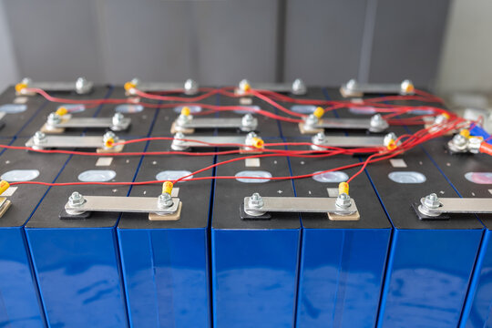 Technician connect BMS (Battery Management System) wires to Lifepo4 battery pack for solar system.  Lifepo4 Battery Management System Concept.