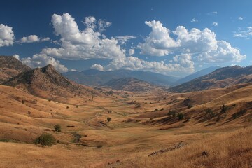Naklejka premium Scenic landscape of arid valley with mountains and dramatic clouds.