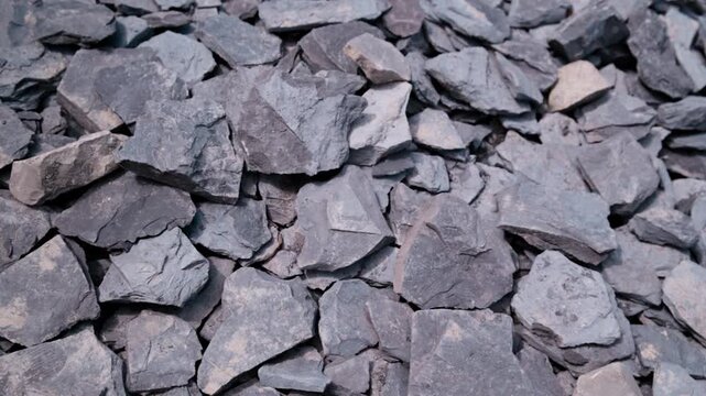 Top-down shot slowly gliding over a vast field of broken Jurassic shale. Countless grey slabs at the Holzmaden quarry, Germany &ndash; each one could hide a fossil sealed away for 180 million years.