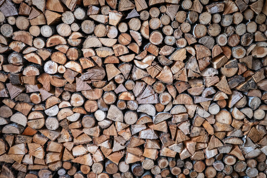 Stacked Firewood Logs Form Natural Wooden Texture Background Pattern
