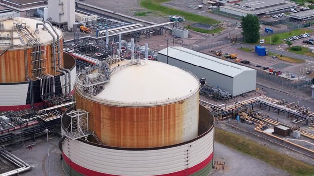 Aerial view of the Liquified Natural Gas LNG Terminal with large storage tanks and industrial infrastructure in Isle of Grain, England, United Kingdom.