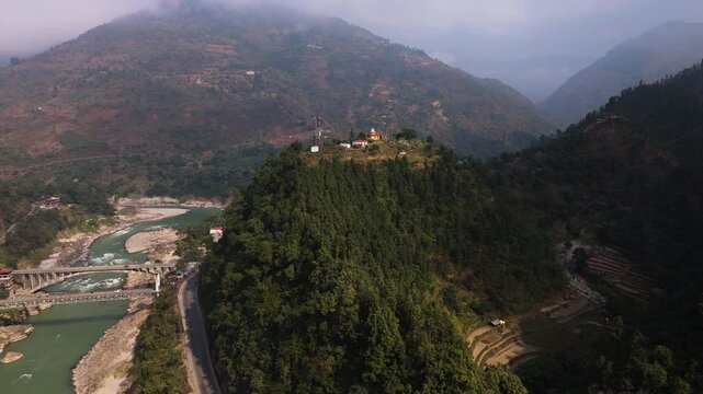 Drone rotating toward a hilltop radar station overlooking the Prithvi Highway in Nepal