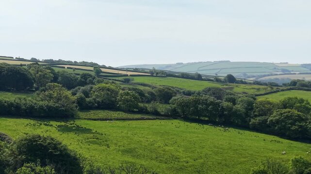 Sideways Drone View of English Countryside with Multiple Lush Green Summer Fields.