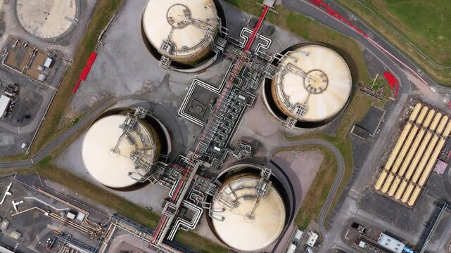 Aerial view of the Liquified Natural Gas LNG Terminal showing storage tanks and industrial piping infrastructure in Isle of Grain, England, United Kingdom.