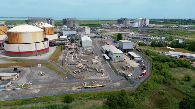 Aerial view of the Liquified Natural Gas LNG Terminal with large storage tanks and industrial infrastructure on the Isle of Grain, England, United Kingdom.