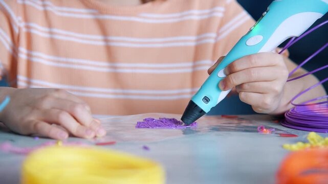 Child using 3D printing pen to create plastic object. Creative hobby and educational activity for kid. Innovative technology for art and design.
