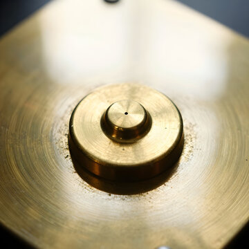 Extreme macro photography profiling the vibrant material truth and structural textures of kinetic brass-weighted desk metronomes.