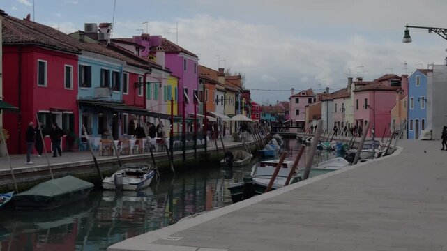 Colorful Venetian Canal With Boats And Everyday Coastal Life